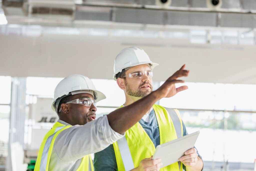 Two construction workers with digital tablet