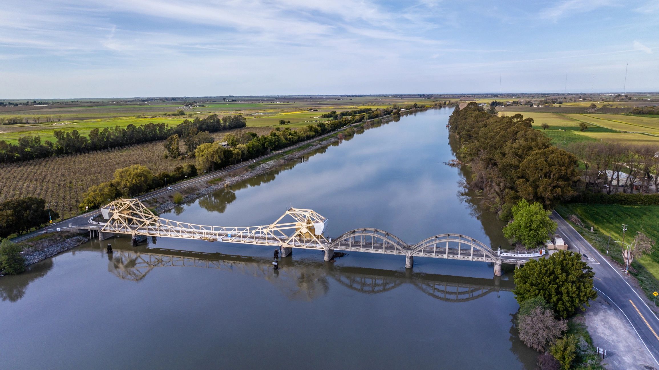 Aerial view of a bridge spanning a river, representing complex infrastructure projects.